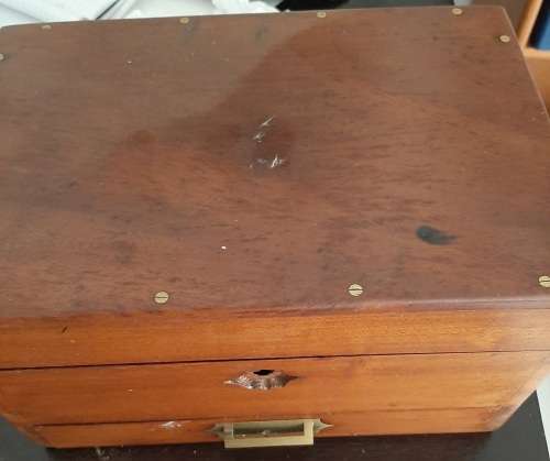 Wooden box with secret compartment filled with a mix or internation coins and costume jewellery